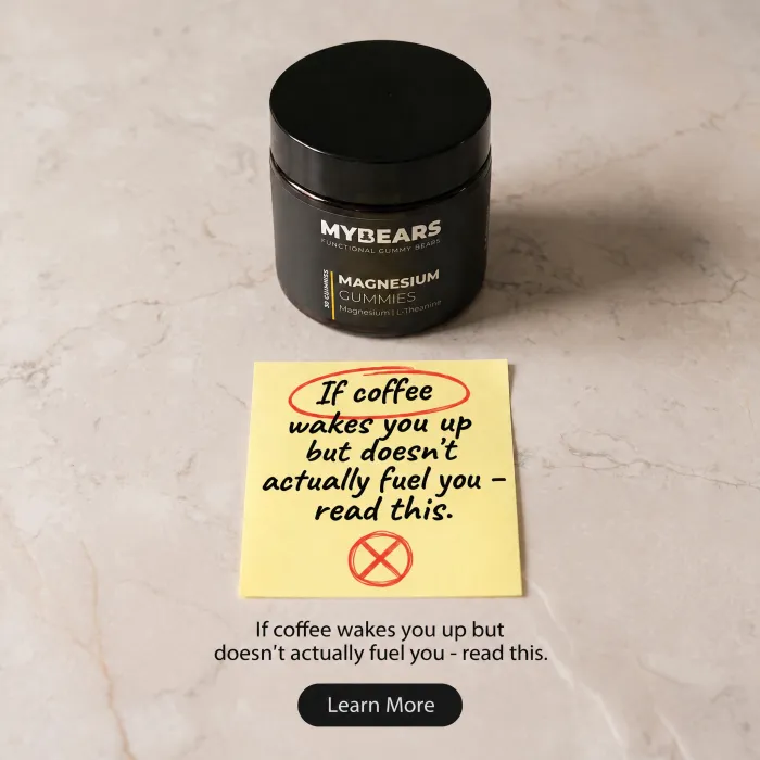 A jar of magnesium gummies on marble beside a yellow sticky note about coffee waking you but not fuelling you.